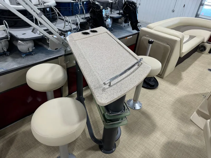 Slide: The Image of 2016 Crest 250 boat interior with bar stools and table setup. - 9