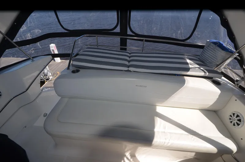 Slide: The Image of 2000 Silverton 330 Sport Bridge interior with striped seating and nautical decor. - 11
