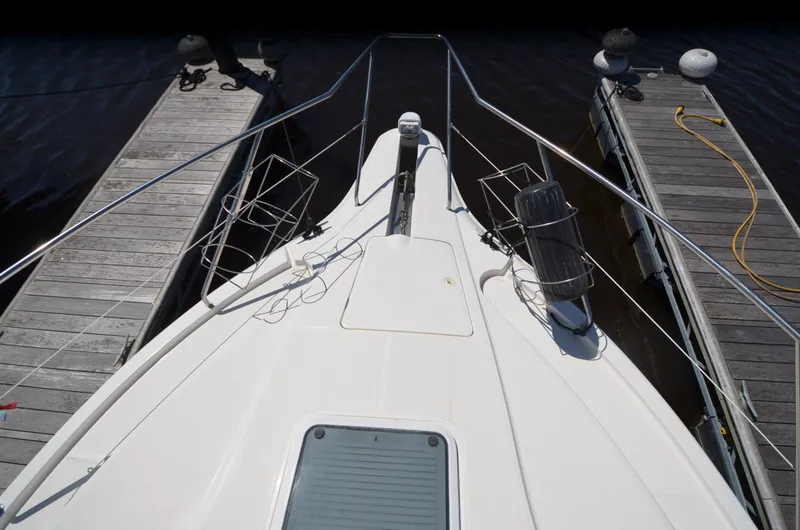 Slide: The Image of 2000 Silverton 330 Sport Bridge yacht docked between wooden piers. - 12