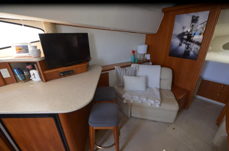 Slide: The Image of Interior of 2000 Silverton 330 Sport Bridge with cozy seating and modern amenities. - 16