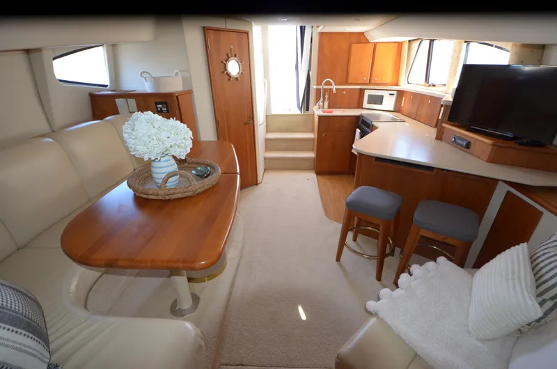 Slide: The Image of Interior of 2000 Silverton 330 Sport Bridge yacht with kitchen, seating, and TV. - 17