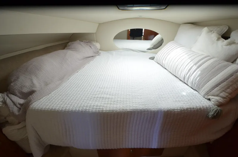 Slide: The Image of Cozy cabin interior of 2000 Silverton 330 Sport Bridge with comfortable bedding. - 18