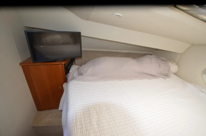 Slide: The Image of Cozy bedroom in 2000 Silverton 330 Sport Bridge with TV and wooden cabinet. - 19