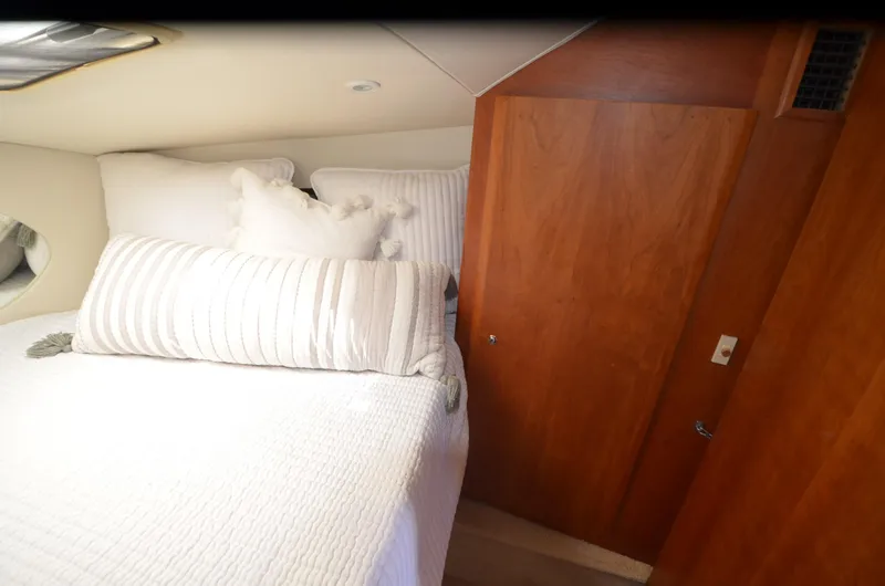Slide: The Image of Interior cabin of 2000 Silverton 330 Sport Bridge with cozy bed and wooden door. - 20