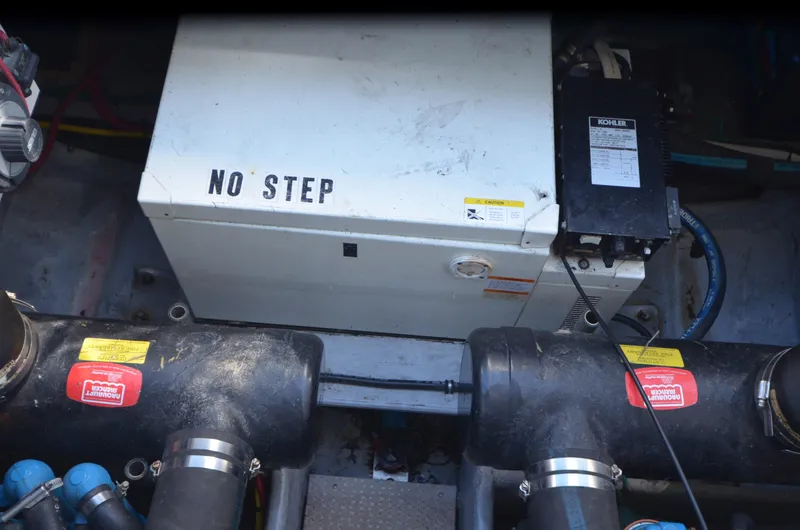 Slide: The Image of Engine compartment of a 2000 Silverton 330 Sport Bridge with "No Step" warning. - 22