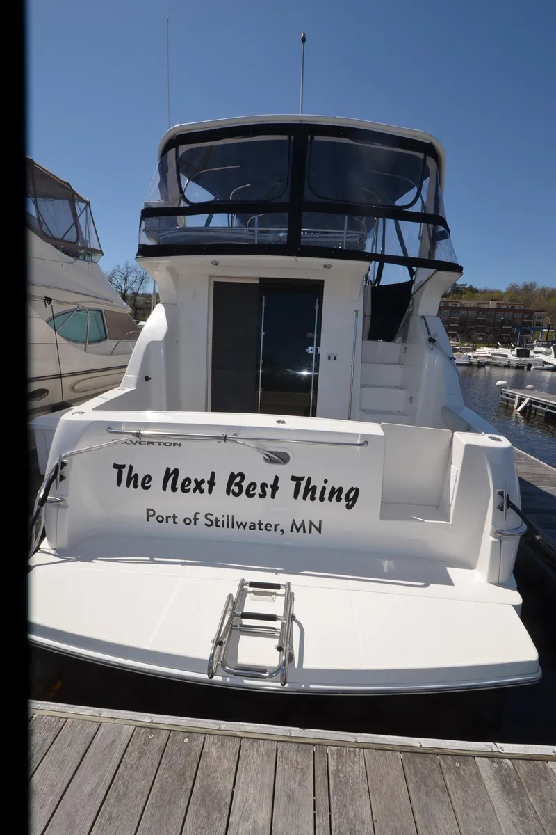 Slide: The Image of 2000 Silverton 330 Sport Bridge docked, rear view, "The Next Best Thing," Stillwater, MN. - 23