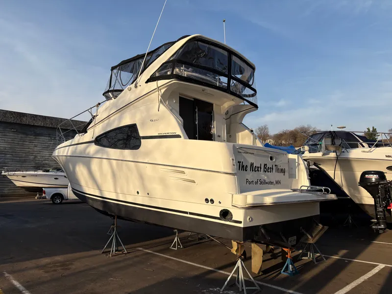 Slide: The Image of 2000 Silverton 330 Sport Bridge yacht on stands, outdoor display. - 29