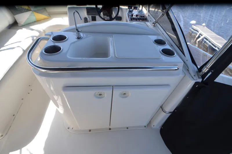 Slide: The Image of 2000 Silverton 330 Sport Bridge yacht interior with sink and storage. - 6