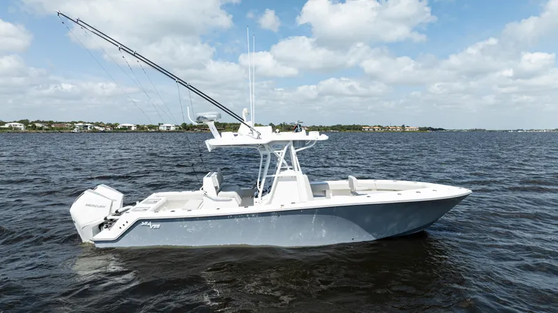 Slide: The Image of 2024 SeaVee 290B boat on open water under a partly cloudy sky. - 0