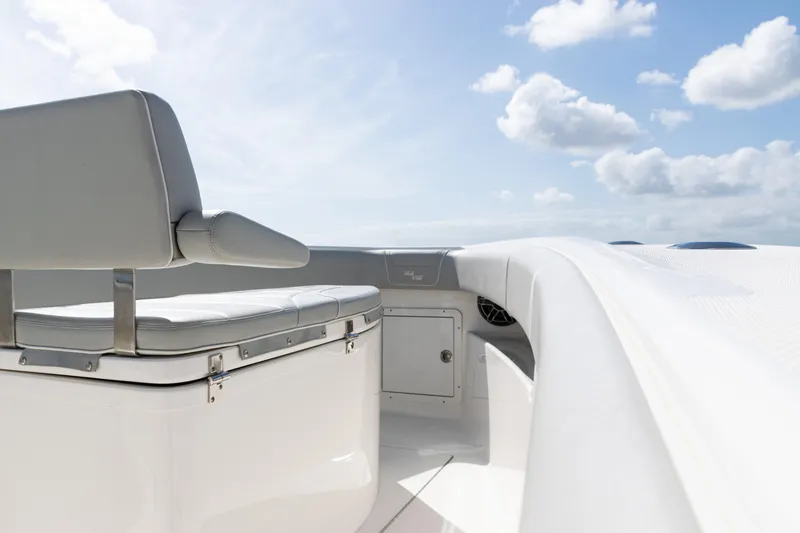 Slide: The Image of 2024 SeaVee 290B boat interior with seating, under a clear blue sky. - 10