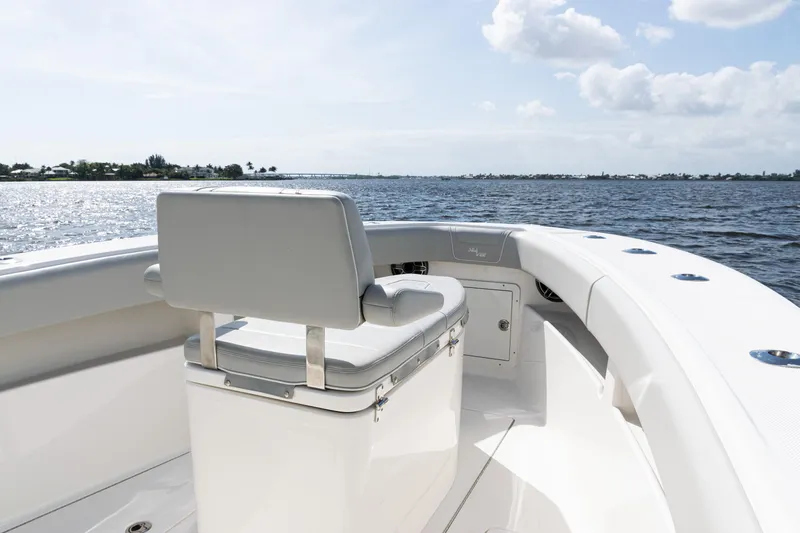 Slide: The Image of 2024 SeaVee 290B boat interior with seating, overlooking calm waters and a clear sky. - 11