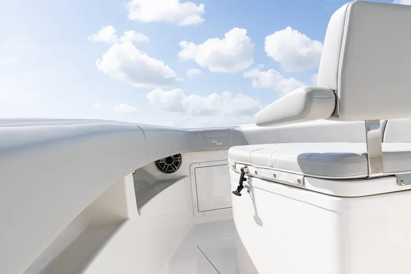 Slide: The Image of 2024 SeaVee 290B boat interior with white seating and clear blue sky. - 12