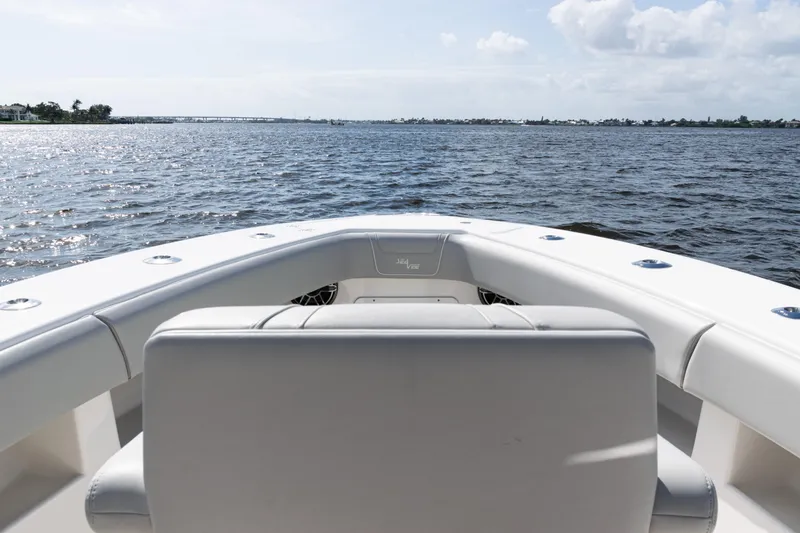 Slide: The Image of 2024 SeaVee 290B boat on calm waters under a partly cloudy sky. - 13