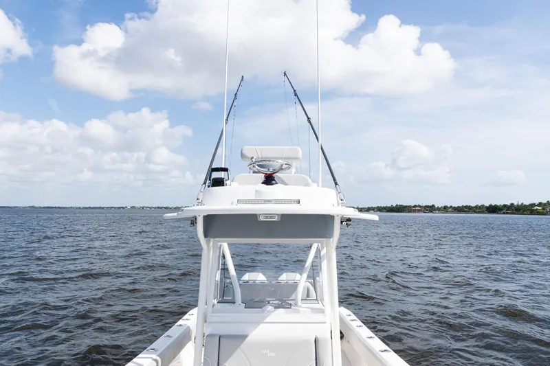 Slide: The Image of 2024 SeaVee 290B boat on open water under a partly cloudy sky. - 16