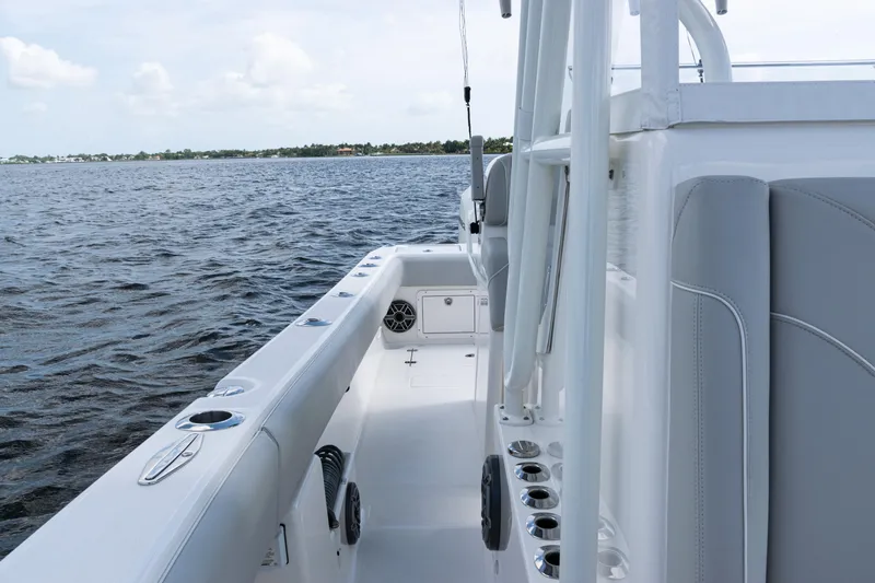 Slide: The Image of 2024 SeaVee 290B boat, sleek design, spacious deck, on calm waters. - 18