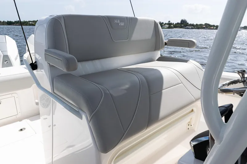 Slide: The Image of 2024 SeaVee 290B boat with gray cushioned seating, on a sunny day at sea. - 24