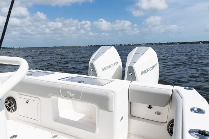 Slide: The Image of 2024 SeaVee 290B boat with dual Mercury engines on open water. - 29