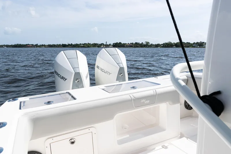 Slide: The Image of 2024 SeaVee 290B boat with dual Mercury engines on a calm water backdrop. - 30