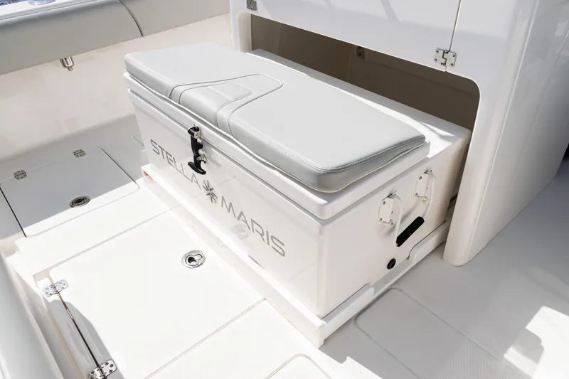 Slide: The Image of 2024 SeaVee 290B boat interior with cushioned storage bench labeled "Stella Maris." - 32
