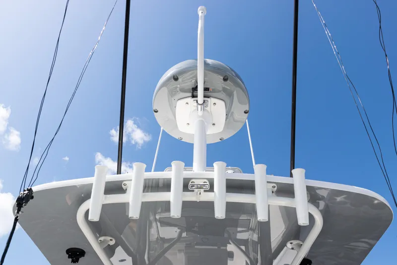 Slide: The Image of 2024 SeaVee 290B boat with radar and rod holders against a clear blue sky. - 33