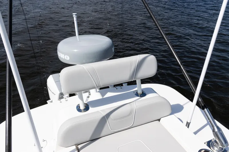 Slide: The Image of 2024 SeaVee 290B boat with cushioned seating and radar, on calm water. - 34