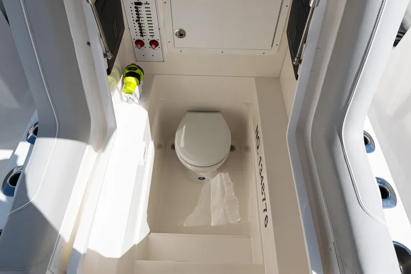 Slide: The Image of 2024 SeaVee 290B boat interior with compact marine toilet and control panel. - 35