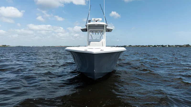 Slide: The Image of 2024 SeaVee 290B boat on open water under a partly cloudy sky. - 4