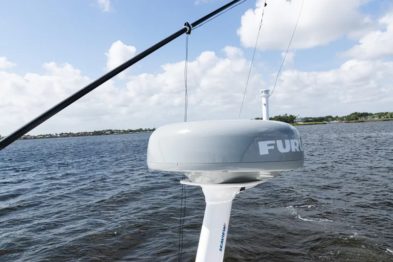 Slide: The Image of 2024 SeaVee 290B boat with Furuno radar on open water under cloudy sky. - 40