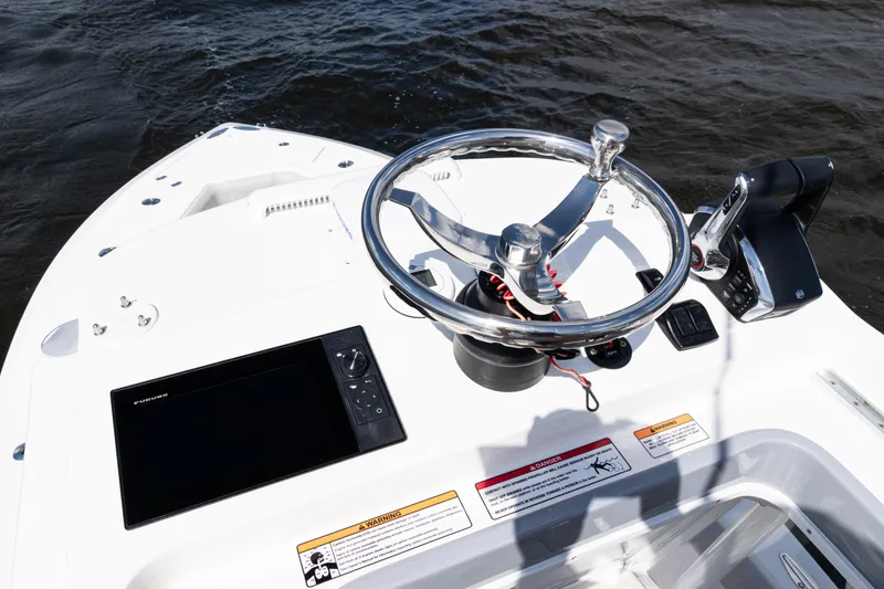 Slide: The Image of 2024 SeaVee 290B boat helm with steering wheel and navigation display. - 42