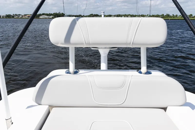 Slide: The Image of 2024 SeaVee 290B boat with white seating, on calm water. - 44