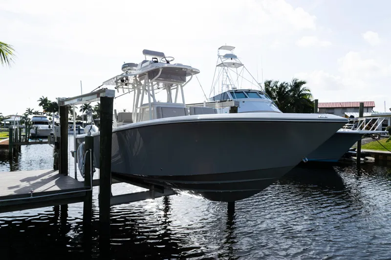Slide: The Image of 2024 SeaVee 290B boat docked in a marina, showcasing sleek design and modern features. - 49