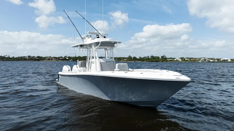 Slide: The Image of 2024 SeaVee 290B boat on open water under a clear blue sky. - 5