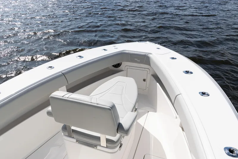 Slide: The Image of 2024 SeaVee 290B boat with sleek seating, cruising on open water. - 6