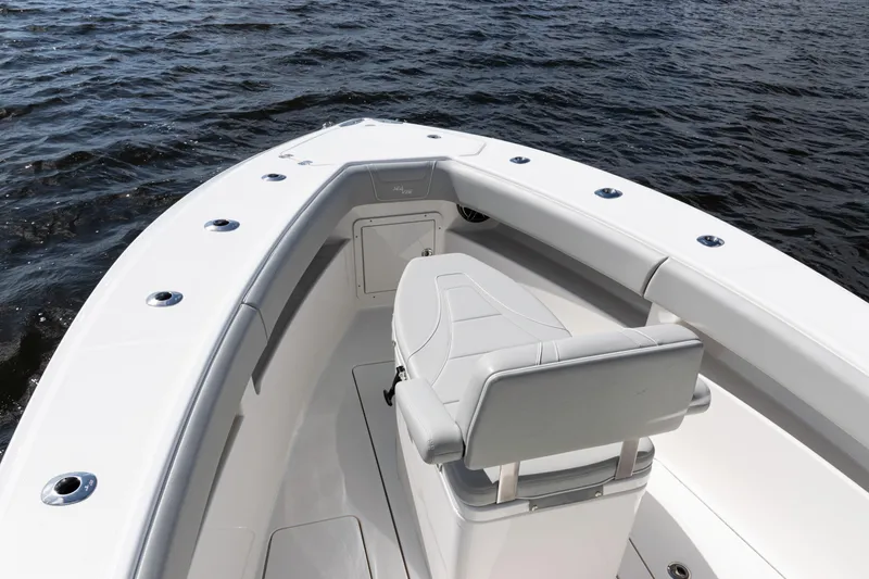 Slide: The Image of 2024 SeaVee 290B boat bow with seating, on calm water. - 8