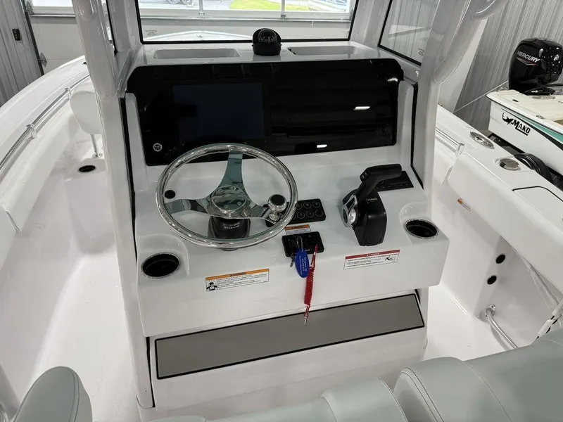Slide: The Image of 2025 Sportsman Open 212 boat console with steering wheel and controls. - 15