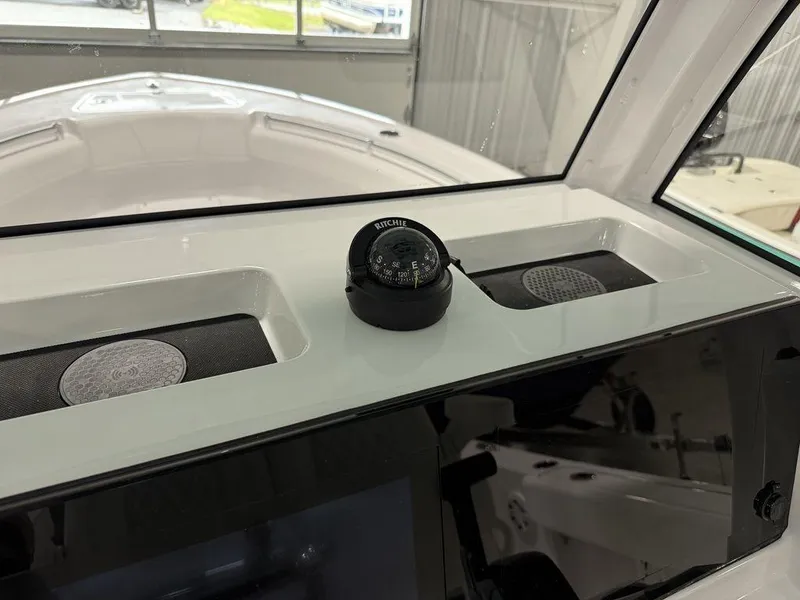Slide: The Image of 2025 Sportsman Open 212 boat dashboard with compass and speakers. - 18