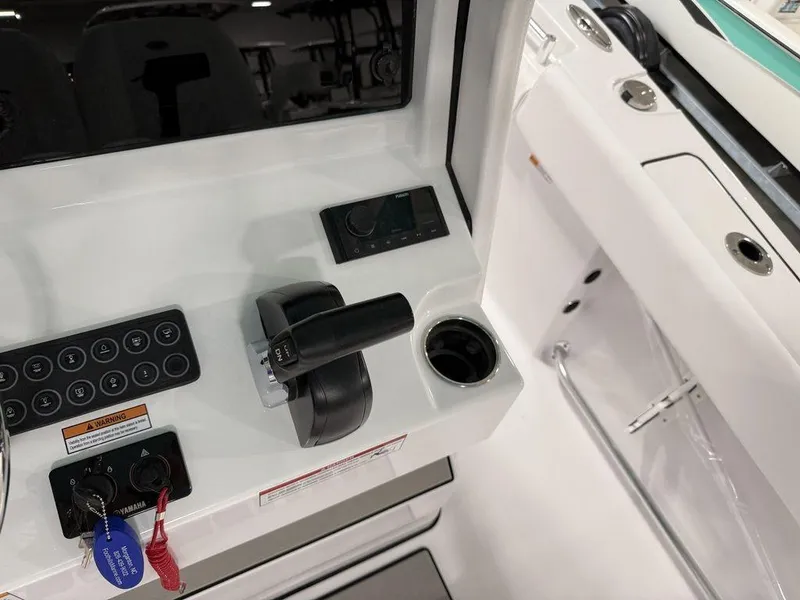 Slide: The Image of Control panel of 2025 Sportsman Open 212 boat with throttle and key switches. - 19