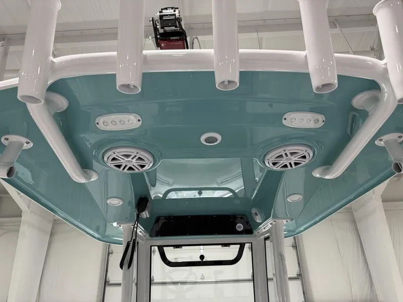 Slide: The Image of 2025 Sportsman Open 212 boat's T-top with speakers and rod holders. - 22