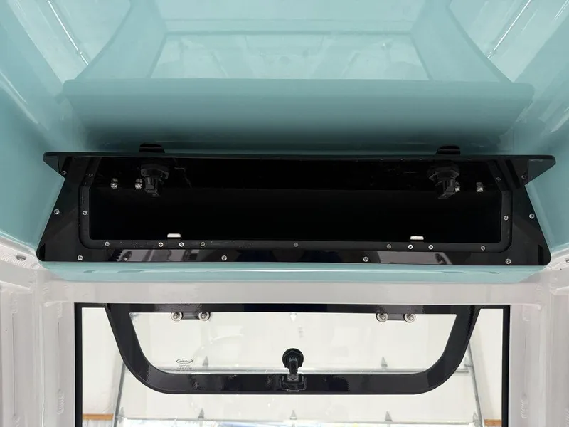 Slide: The Image of 2025 Sportsman Open 212 boat interior storage compartment, open and empty. - 23