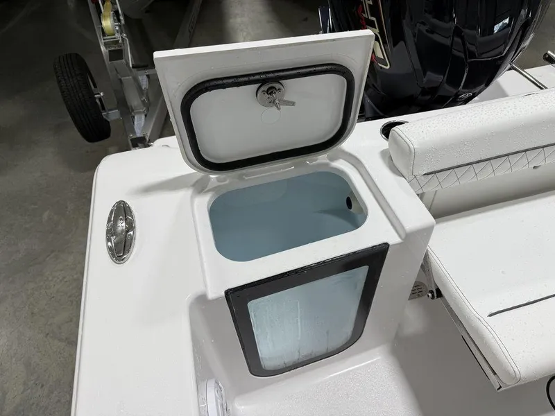 Slide: The Image of 2025 Sportsman Open 212 boat storage compartment with open lid, showcasing interior space. - 25
