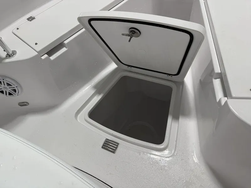 Slide: The Image of 2025 Sportsman Open 212 boat storage compartment with open hatch, showcasing interior space. - 6