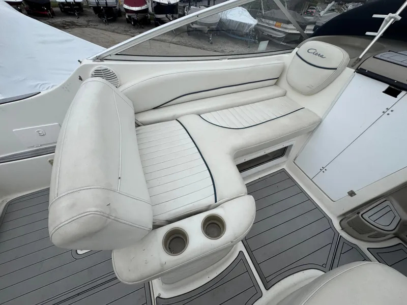 Slide: The Image of 2002 Bayliner 2455 Ciera boat interior with white seating and cup holders. - 18