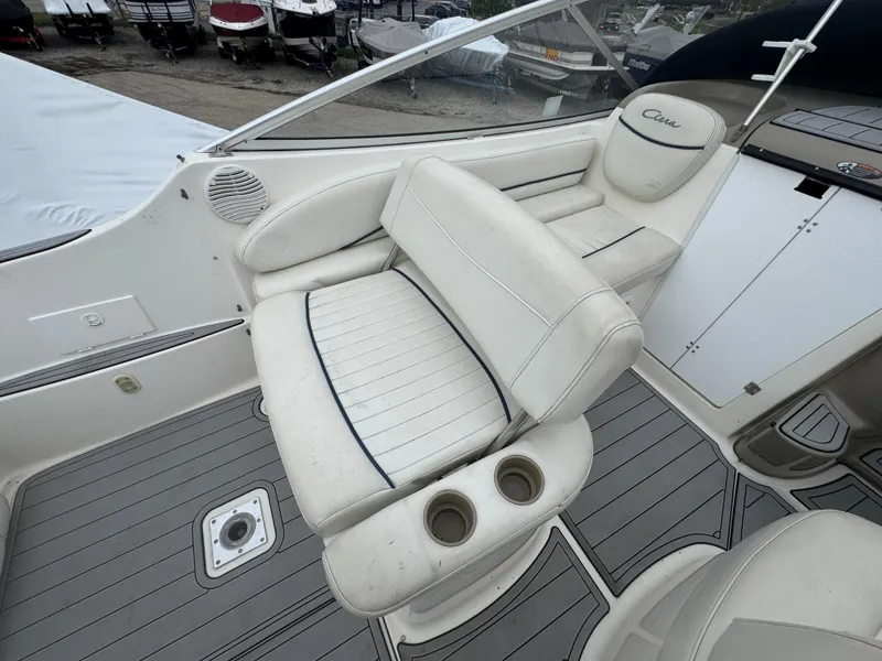 Slide: The Image of 2002 Bayliner 2455 Ciera boat interior with white seating and cup holders. - 19