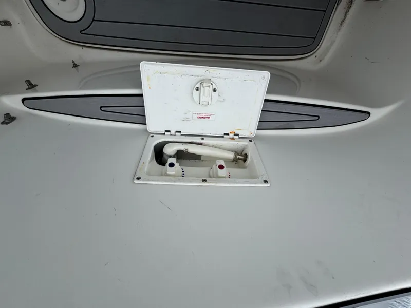 Slide: The Image of 2002 Bayliner 2455 Ciera deck with open hatch and visible fittings. - 21