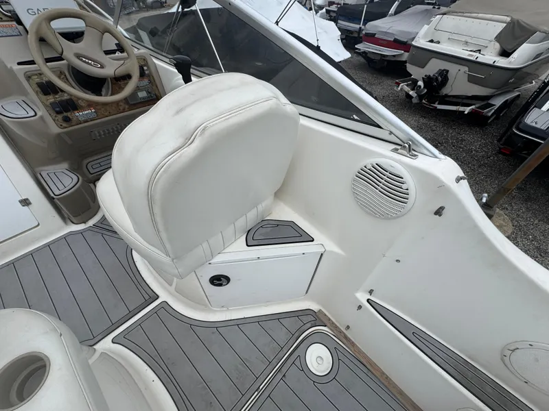 Slide: The Image of 2002 Bayliner 2455 Ciera boat interior with white seating and steering area. - 22