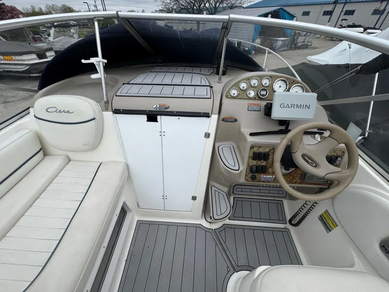 Slide: The Image of 2002 Bayliner 2455 Ciera boat interior with Garmin navigation and sleek dashboard design. - 24