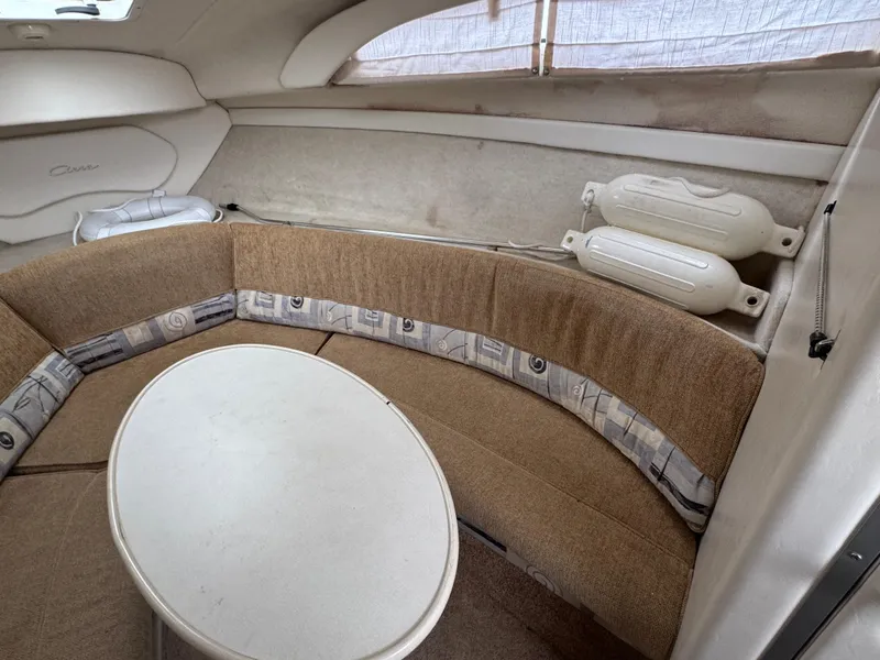Slide: The Image of Interior of 2002 Bayliner 2455 Ciera with beige seating and round table. - 26