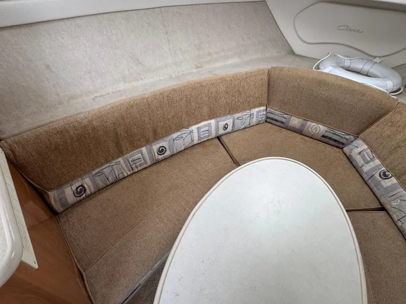Slide: The Image of Interior seating area of a 2002 Bayliner 2455 Ciera boat with beige upholstery. - 27