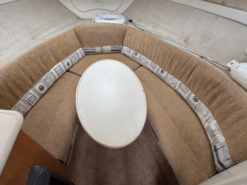 Slide: The Image of 2002 Bayliner 2455 Ciera cabin interior with oval table and cushioned seating. - 28