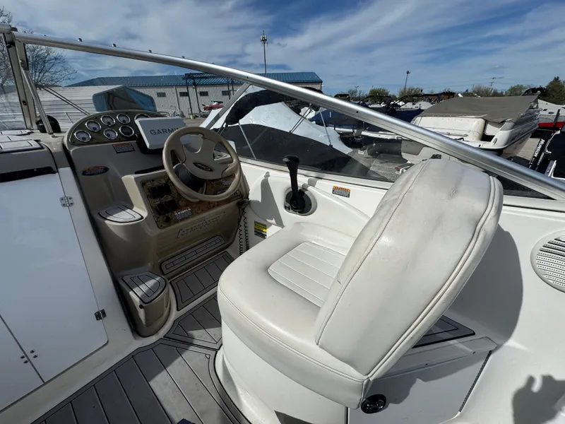 Slide: The Image of 2002 Bayliner 2455 Ciera boat cockpit with steering wheel and captain's chair. - 3